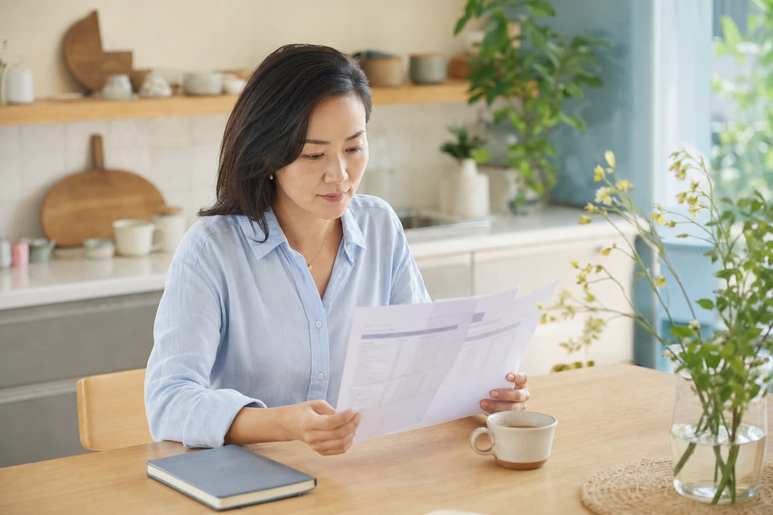 A person reviewing a lab report and wellness notes at a table